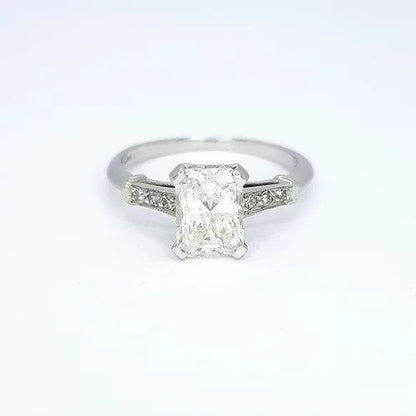 Radiant Cut Diamond Solitaire Engagement Ring; featuring a 1.18 carat radiant-cut diamond, accented with diamond set shoulders, in platinum