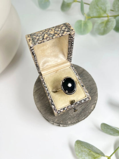 Art Deco 18 Carat Two Colour Gold Oval Onyx and Diamond Halo Ring, Circa 1920