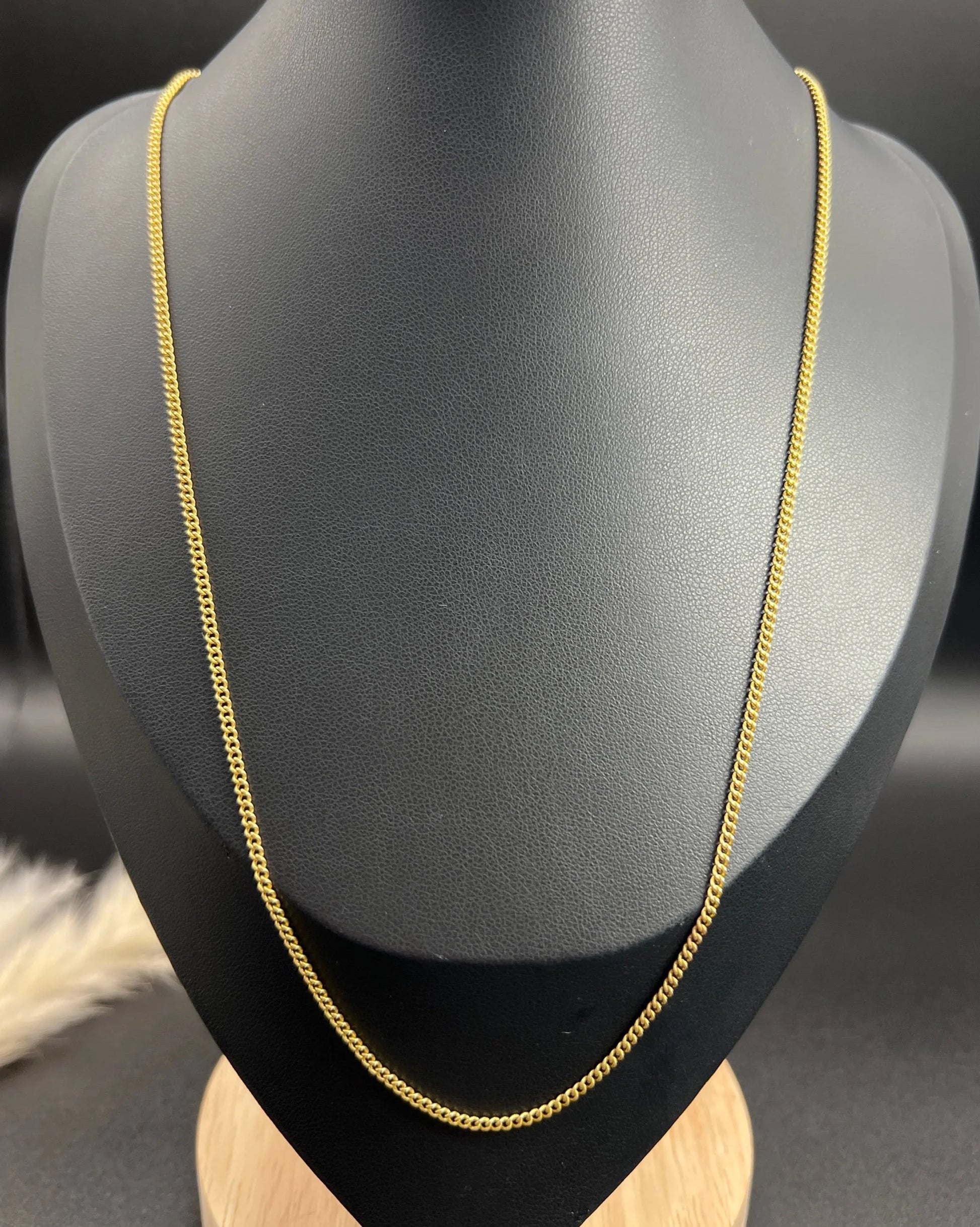 A fine curb link chain necklace in yellow gold