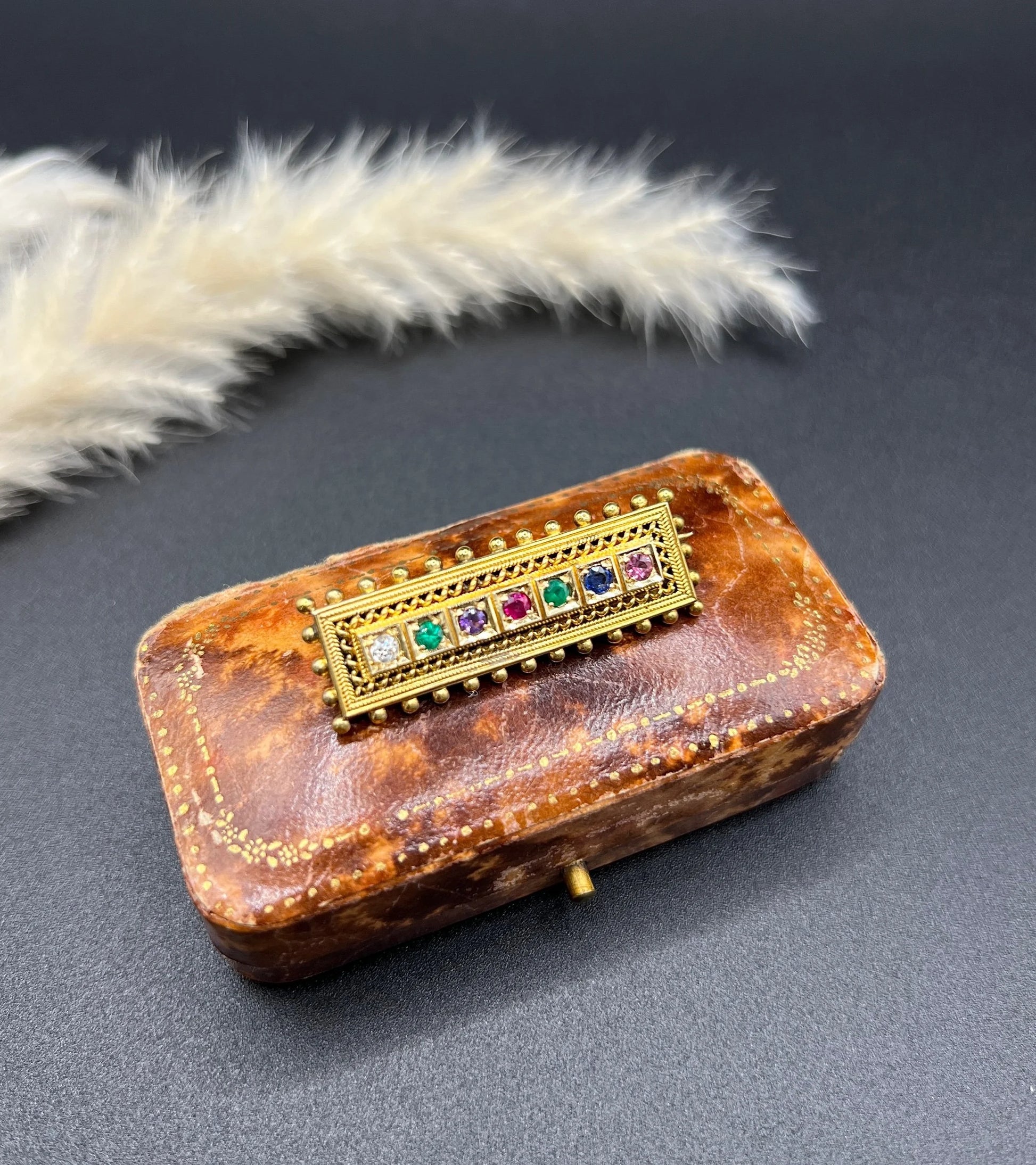 A yellow gold multi-gemstone and diamond acrostic brooch