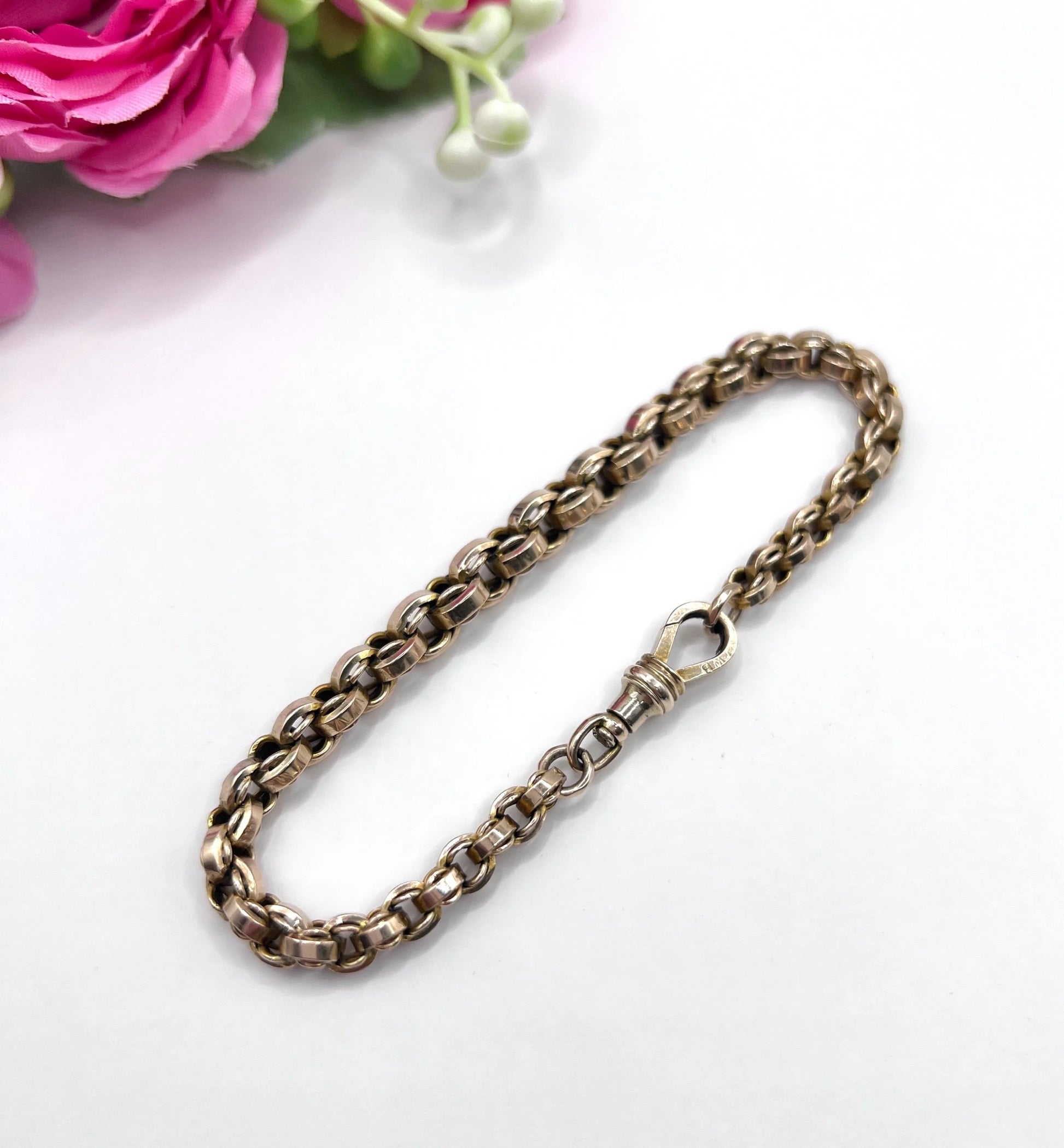 A gold round link bracelet with a lobster claw clasp
