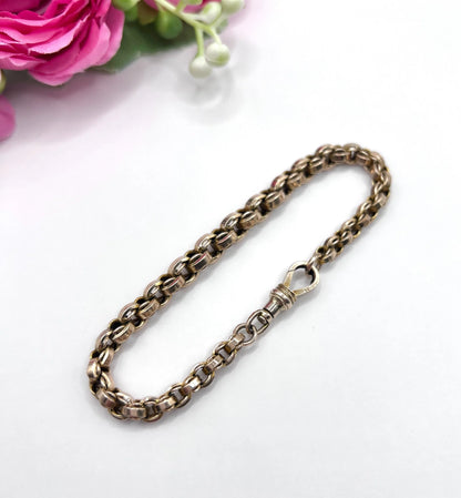 A gold round link bracelet with a lobster claw clasp