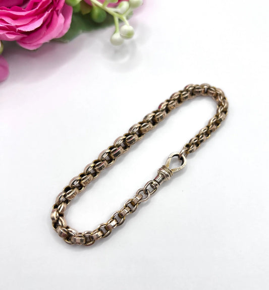 A gold round link bracelet with a lobster claw clasp