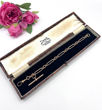 A rose gold link bracelet with a T-bar, in an antique box