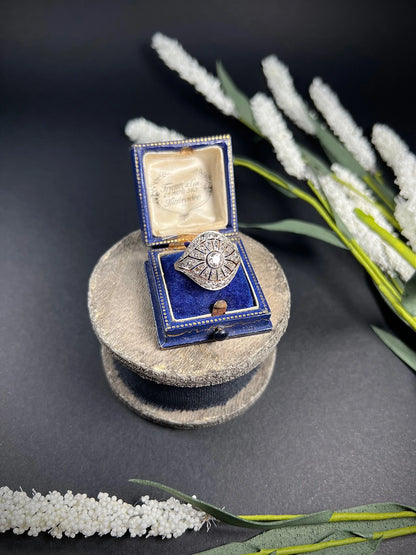 A diamond cocktail ring in yellow and white metal, in an antique ring box