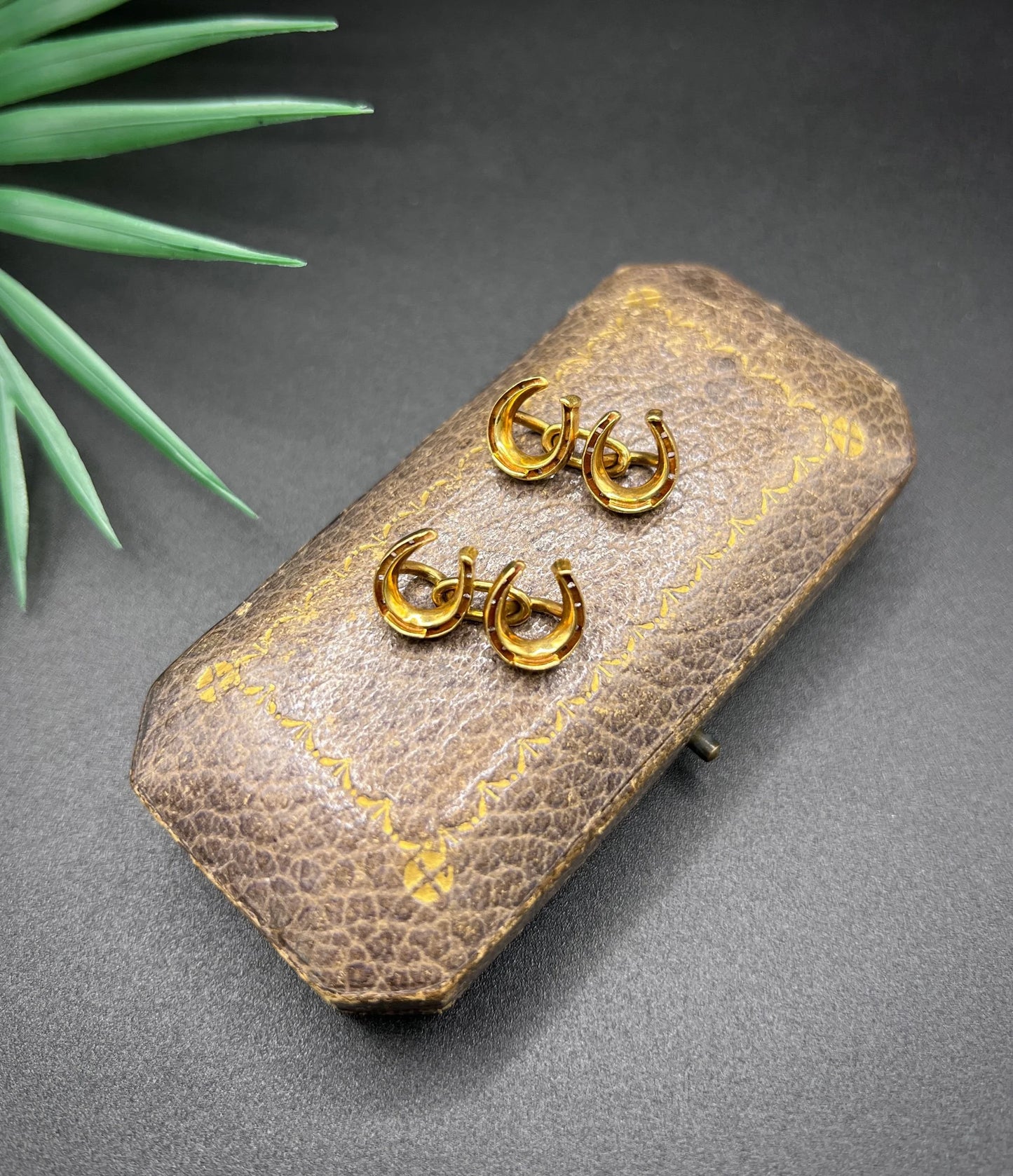 A pair of double-sided horseshoe cufflinks in yellow gold