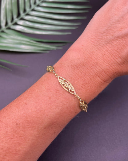 A yellow gold floral link bracelet, modelled on a wrist