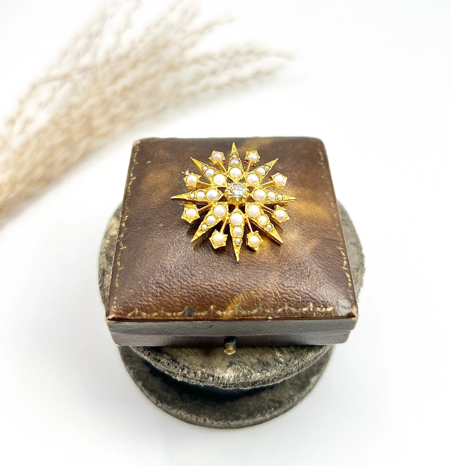 A star-shaped pearl and diamond brooch/pendant in yellow gold
