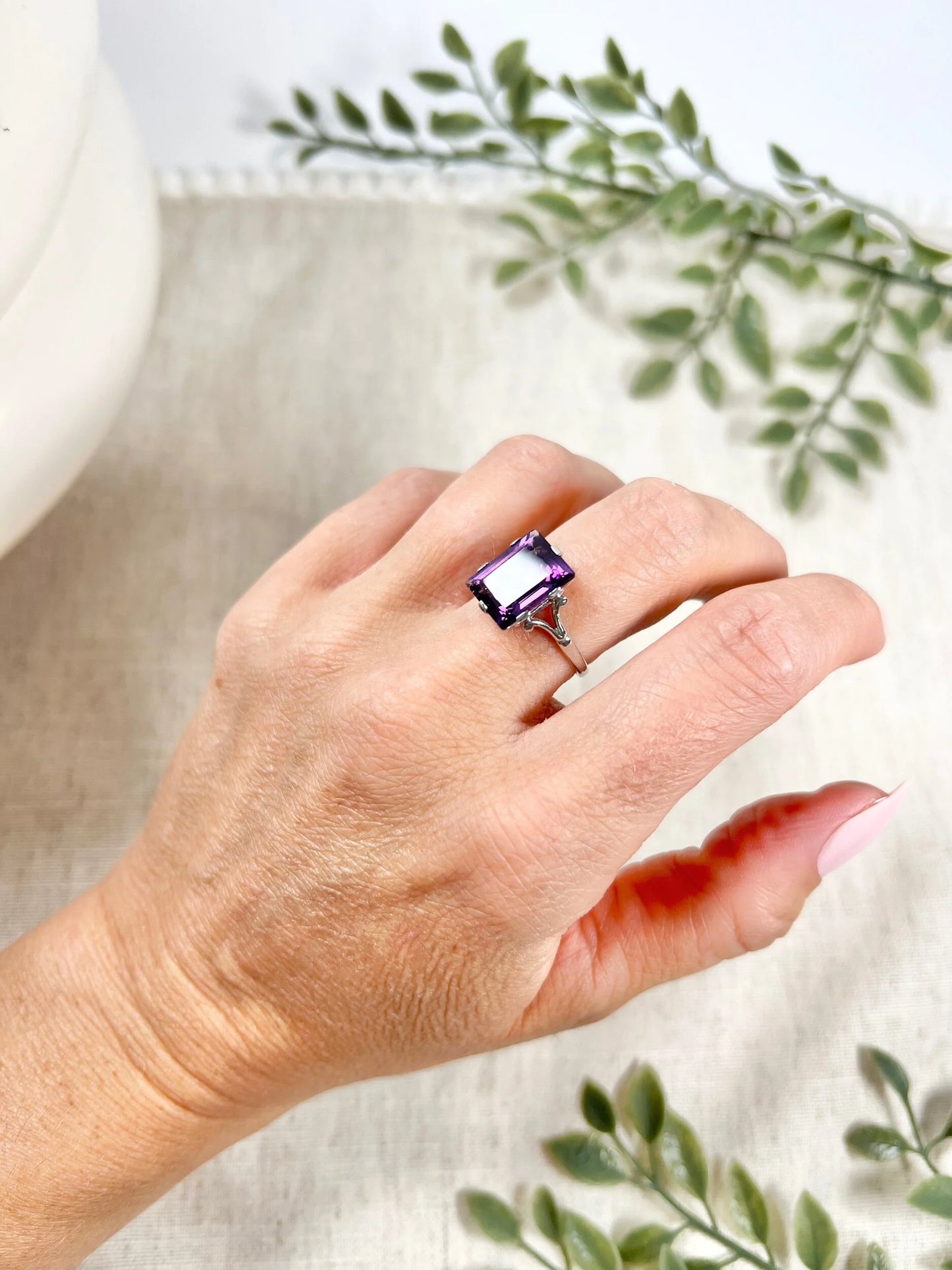A solitaire amethyst cocktail ring in platinum, modelled on a hand