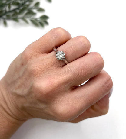 A solitaire round diamond ring in white gold, modelled on a hand