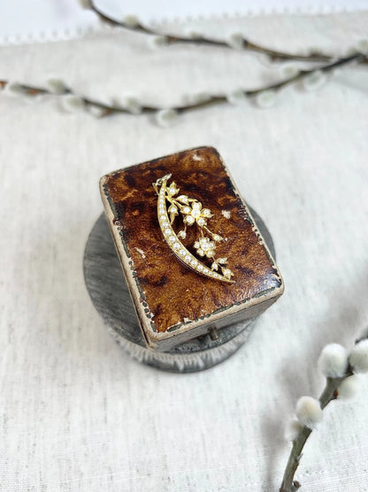 A yellow gold floral crescent pendant with pearls