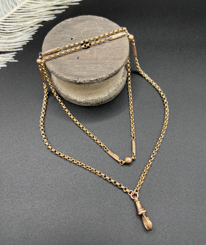 A long rose gold chain necklace with a dog clip clasp