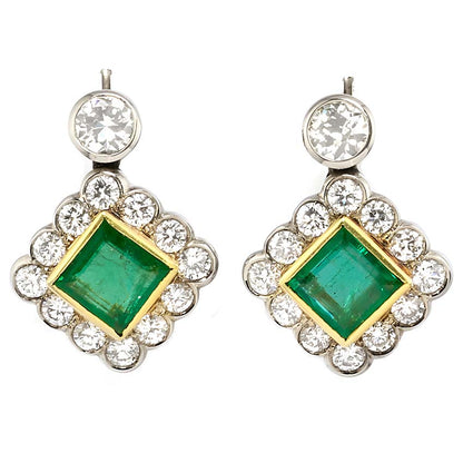 Art Deco 3.54ct Colombian Emerald and 5.75ct Diamond Cluster Drop Earrings, 3.54cts square-shaped step-cut Colombian emeralds surrounded by early brilliant-cut diamonds suspended from old European-cut diamond solitaire tops in 18ct gold. Circa 1935