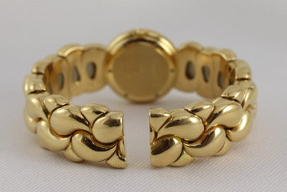 Chopard Casmir Ladies 18ct Yellow Gold Bangle Watch; with Mother of Pearl dial featuring factory set diamond hour markers, protected by sapphire crystal, Quartz movement, with Chopard box