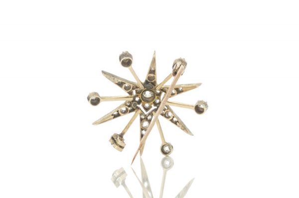 Antique Victorian Old Cut Diamond Star Brooch; set with rose cut and old European cut diamonds, 0.88 carat total, set in silver and 15ct gold