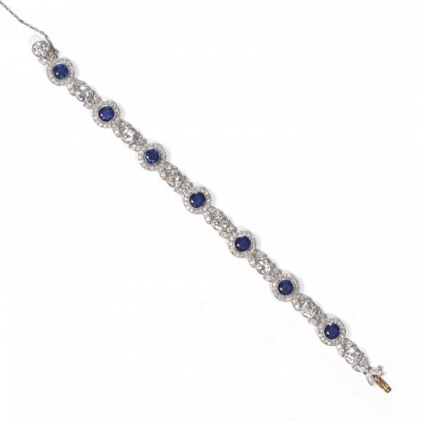 Belle Epoque Burmese Sapphire and Old Cut Diamond Bracelet in Platinum; comprised of round Burmese sapphire and diamond clusters, connected by diamond-set leaf motifs with a round old-cut diamond between each. Circa 1900. Sapphires 5.25 carats, Diamonds 9.50 carats