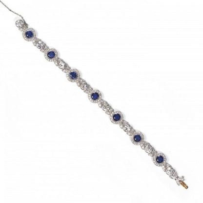 Belle Epoque Burmese Sapphire and Old Cut Diamond Bracelet in Platinum; comprised of round Burmese sapphire and diamond clusters, connected by diamond-set leaf motifs with a round old-cut diamond between each. Circa 1900. Sapphires 5.25 carats, Diamonds 9.50 carats