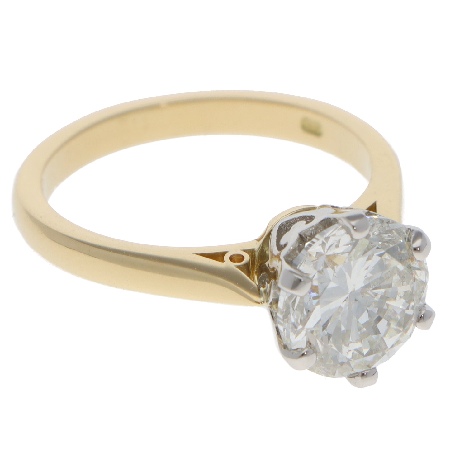 A single stone round brilliant cut diamond ring in yellow gold and platinum, on a white background