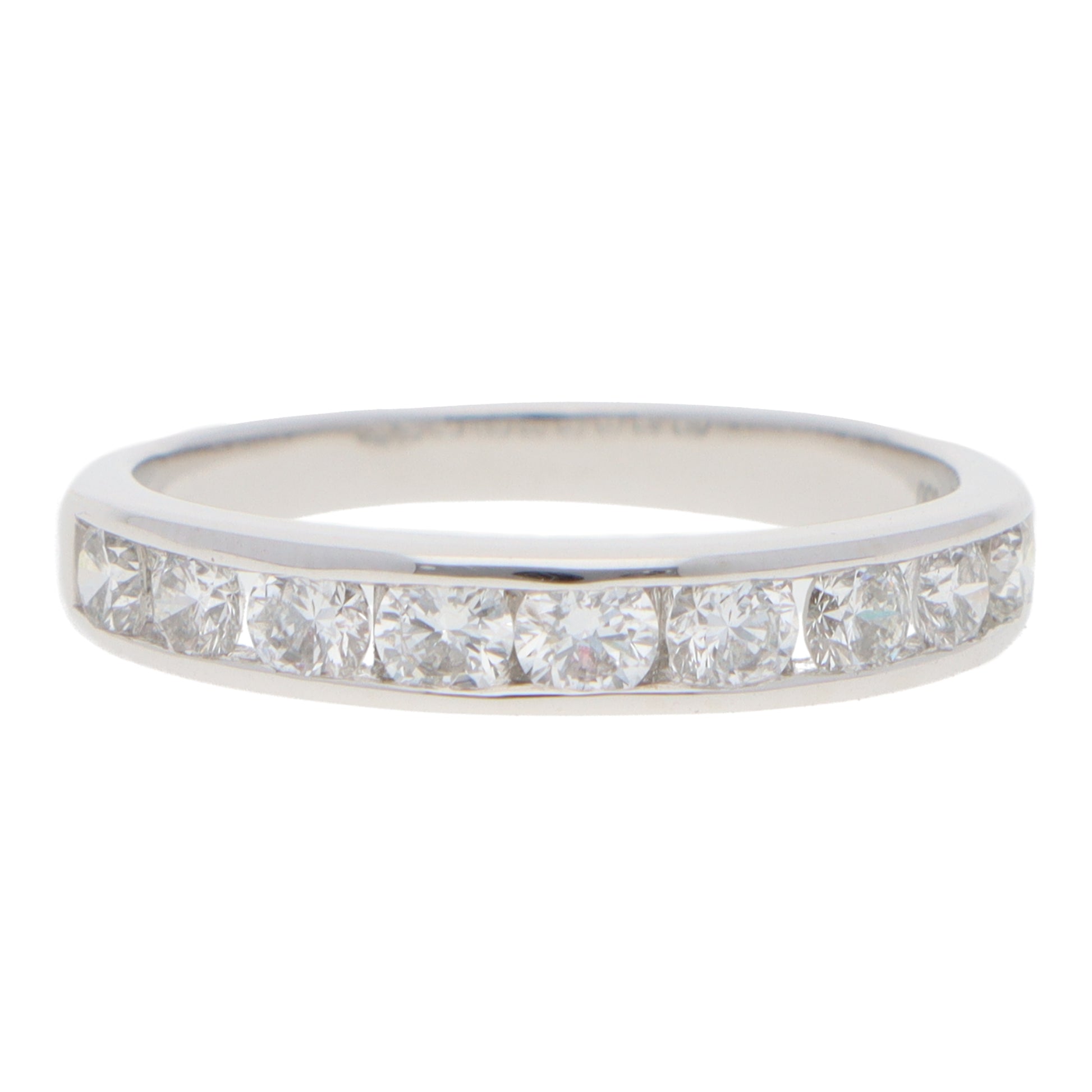 A brilliant cut diamond channel set half eternity band ring, on a white background