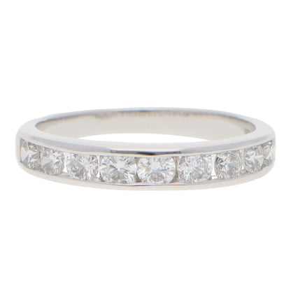 A brilliant cut diamond channel set half eternity band ring, on a white background