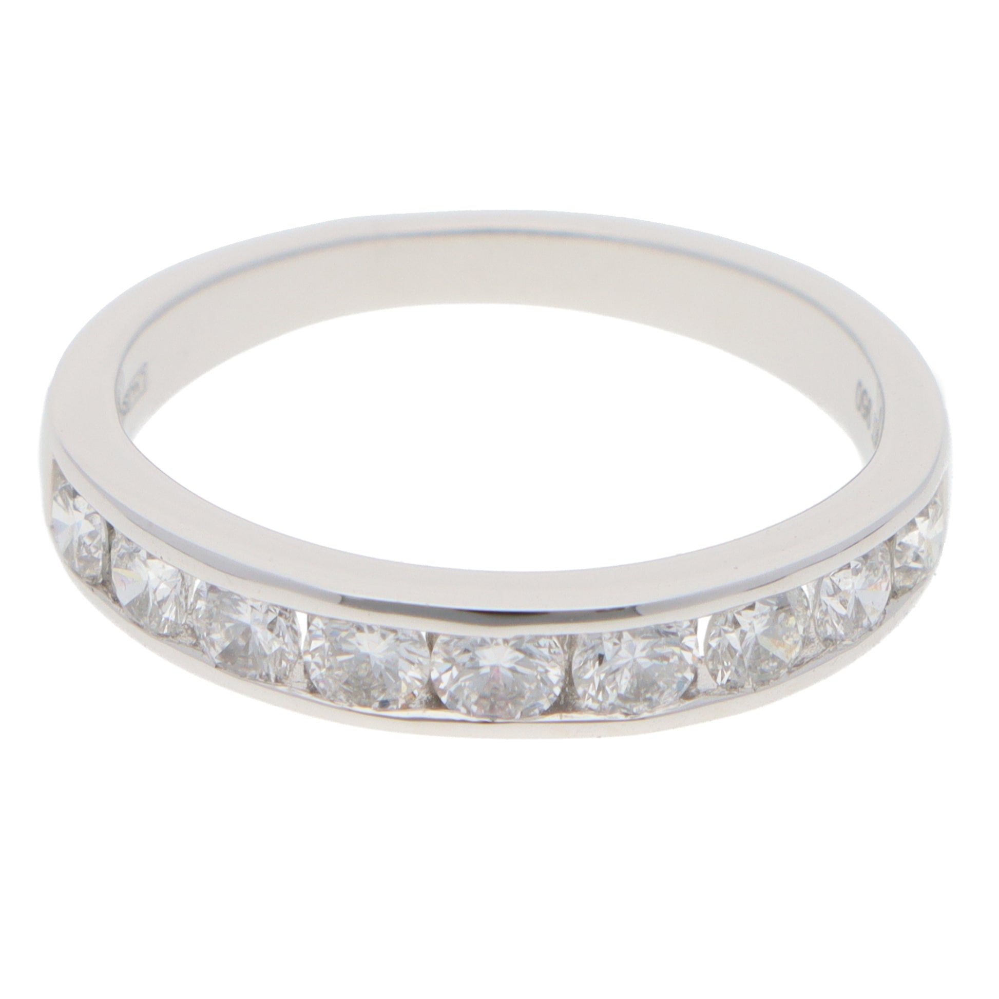 A brilliant cut diamond channel set half eternity band ring, on a white background