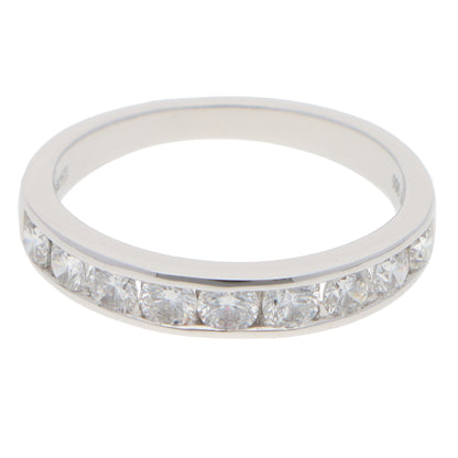A brilliant cut diamond channel set half eternity band ring, on a white background