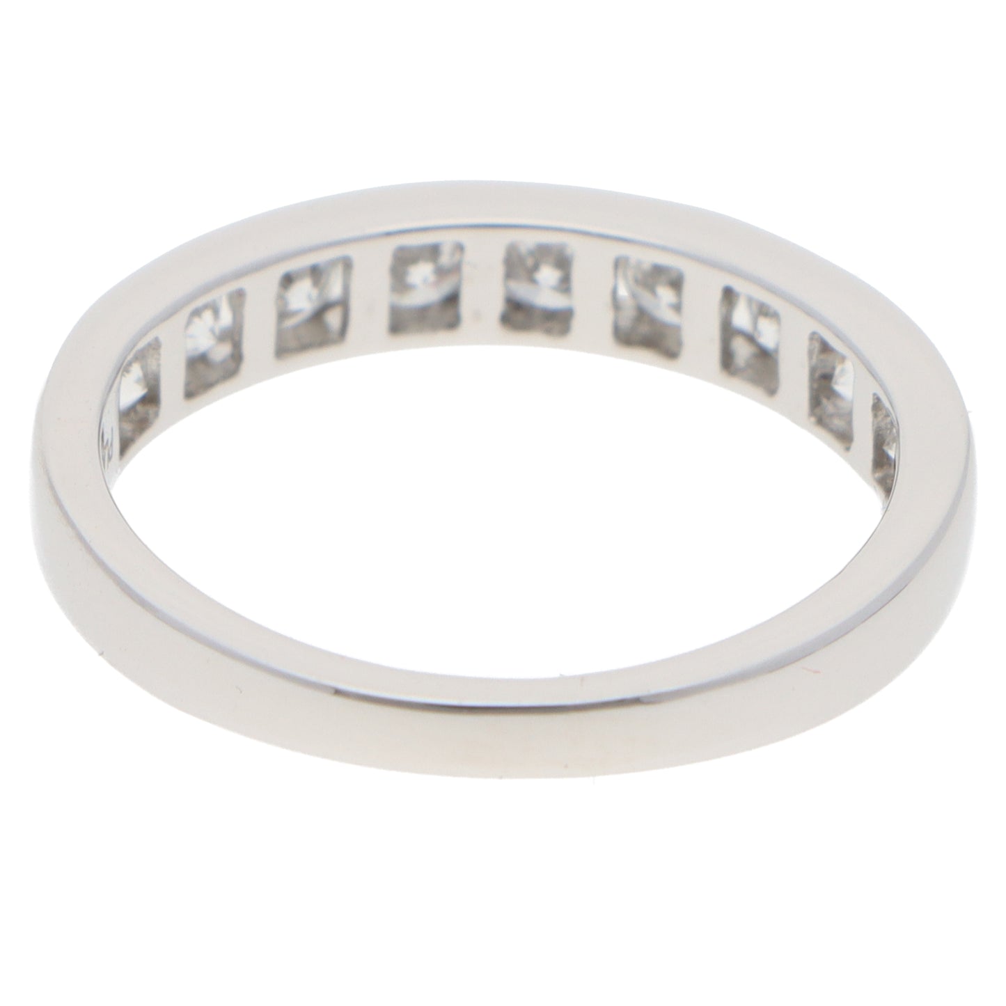 A brilliant cut diamond channel set half eternity band ring, on a white background
