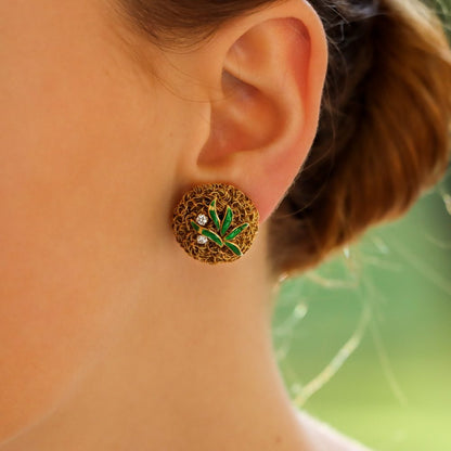 A pair of gold wire work clips earrings set with enamel leaves and diamonds.