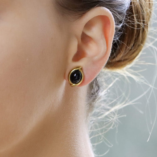 Onyx cabochon clip-on earrings in gold.