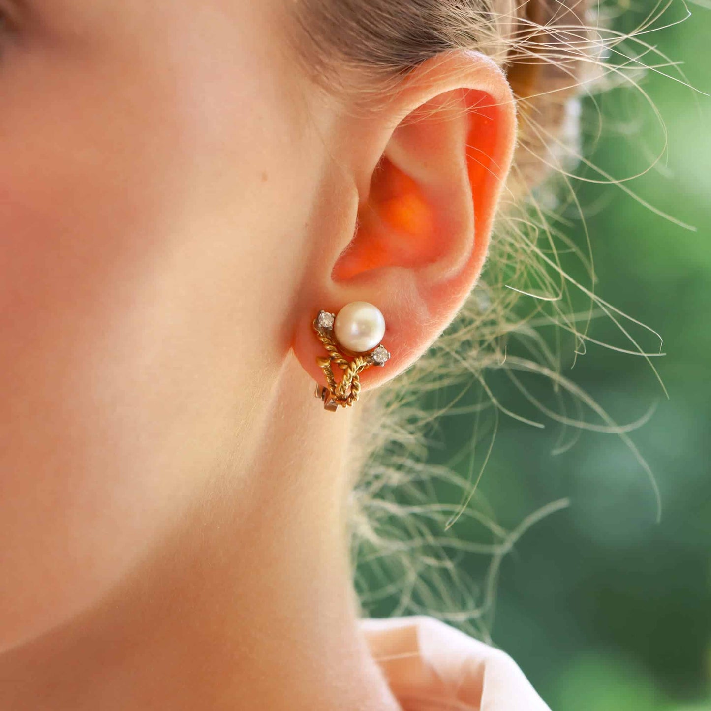 Pearl and diamond twisted rope earrings in gold.