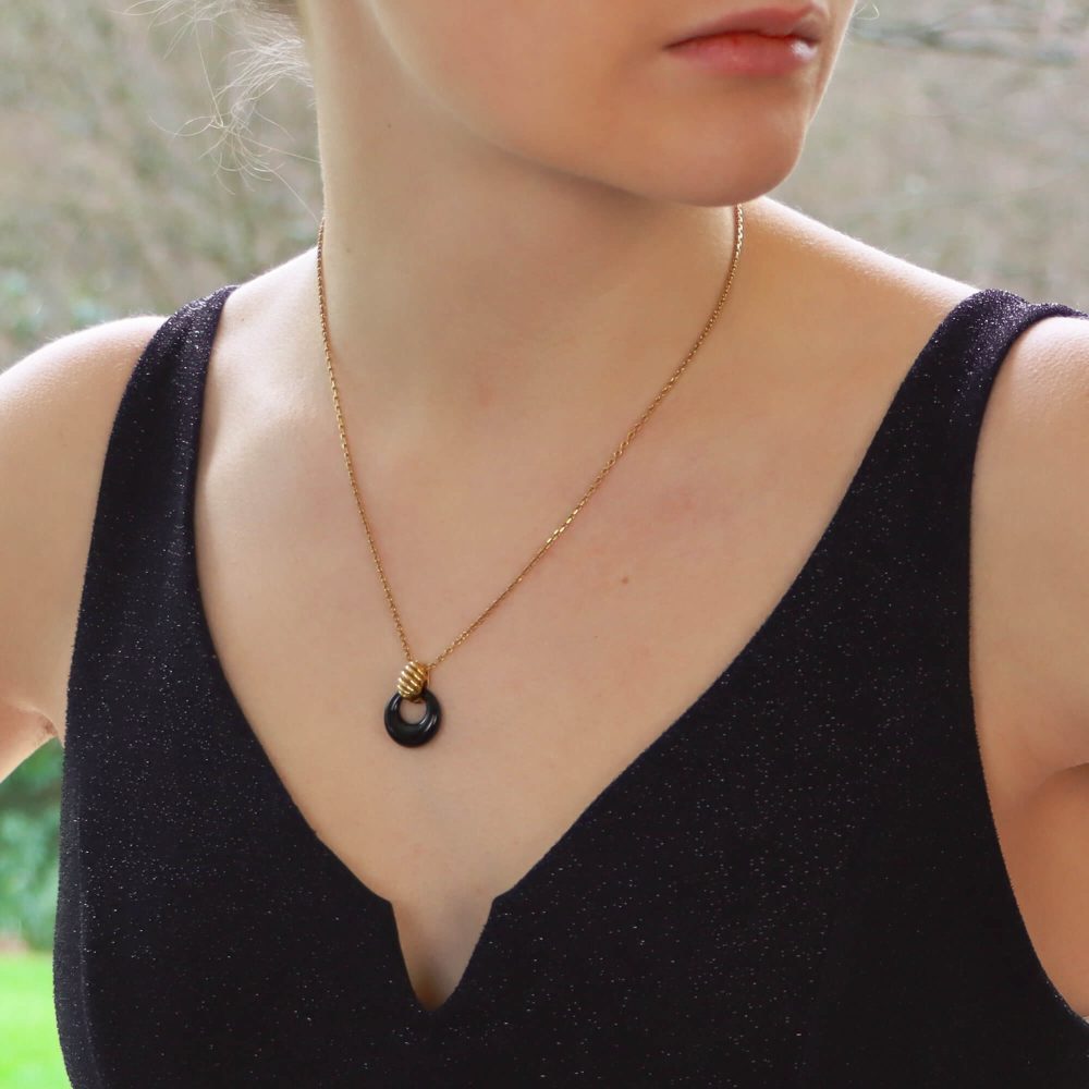 Van Cleef & Arpels onyx disk pendant necklace in gold.