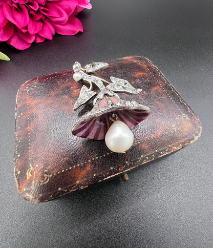 A pink enamel, diamond and pearl flower pendant in gold and silver