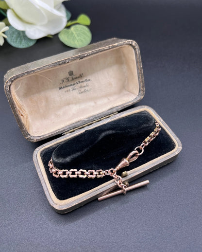 A fancy link rose gold bracelet with a T-bar and dog clip clasp, in an antique box