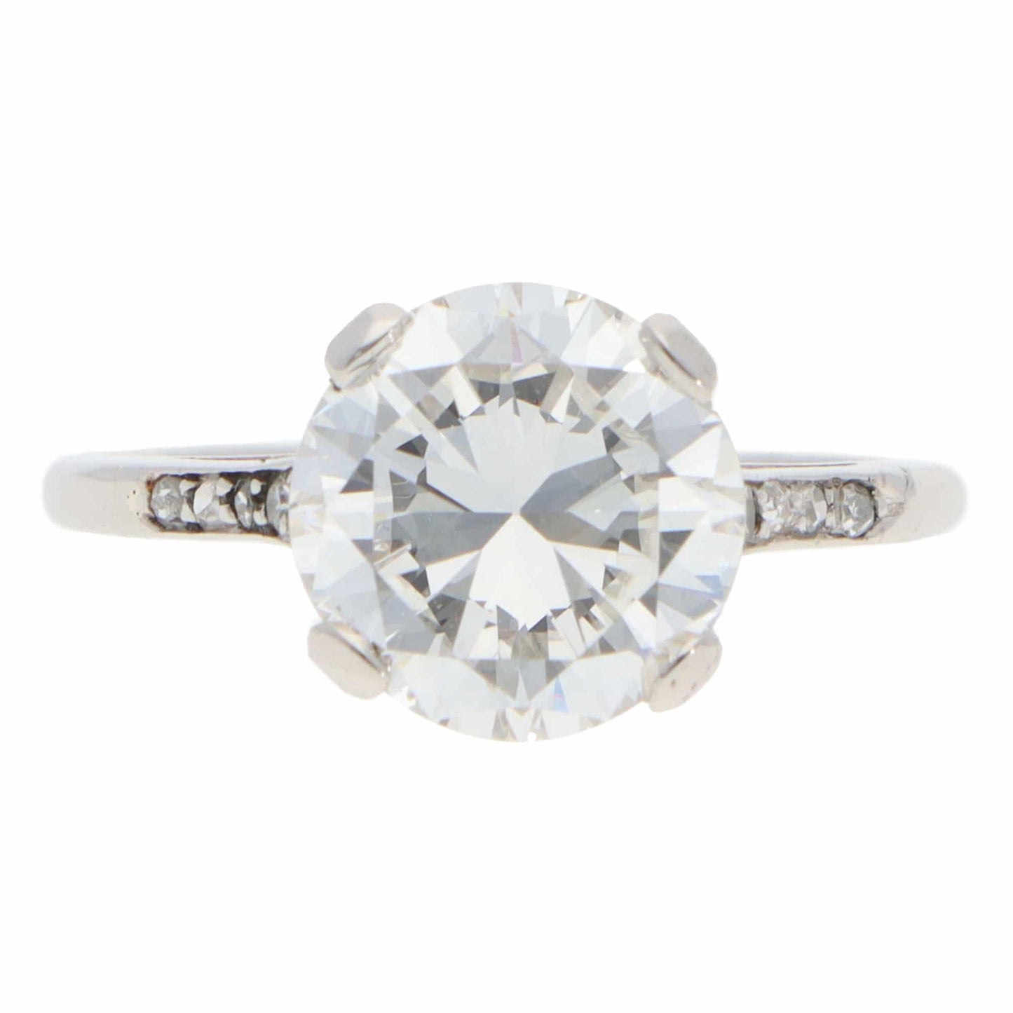 A large round brilliant cut diamond ring in platinum, on a white background
