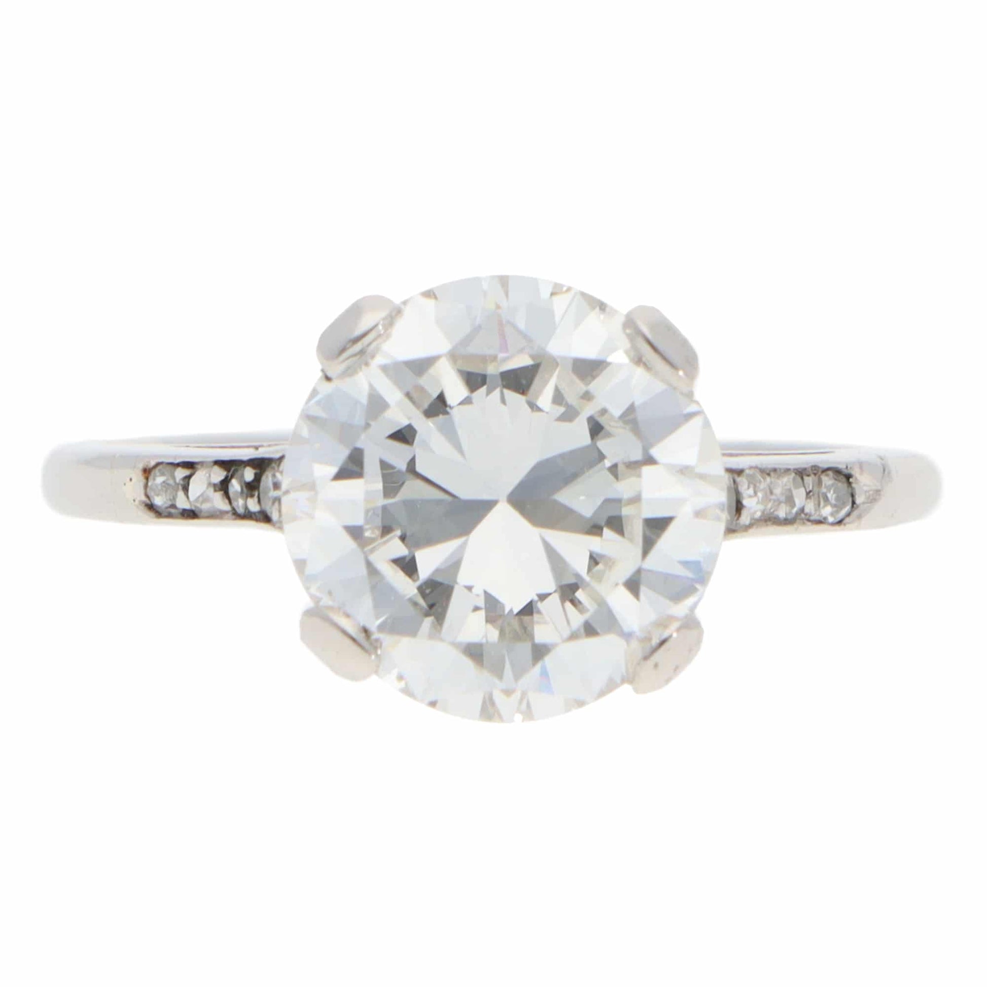 A large round brilliant cut diamond ring in platinum, on a white background