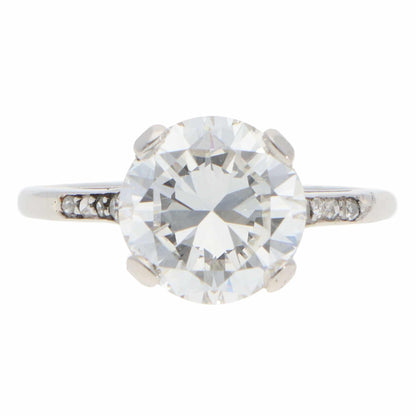 A large round brilliant cut diamond ring in platinum, on a white background