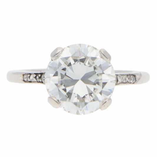 A large round brilliant cut diamond ring in platinum, on a white background