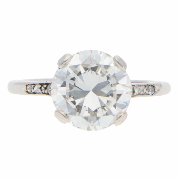A large round brilliant cut diamond ring in platinum, on a white background