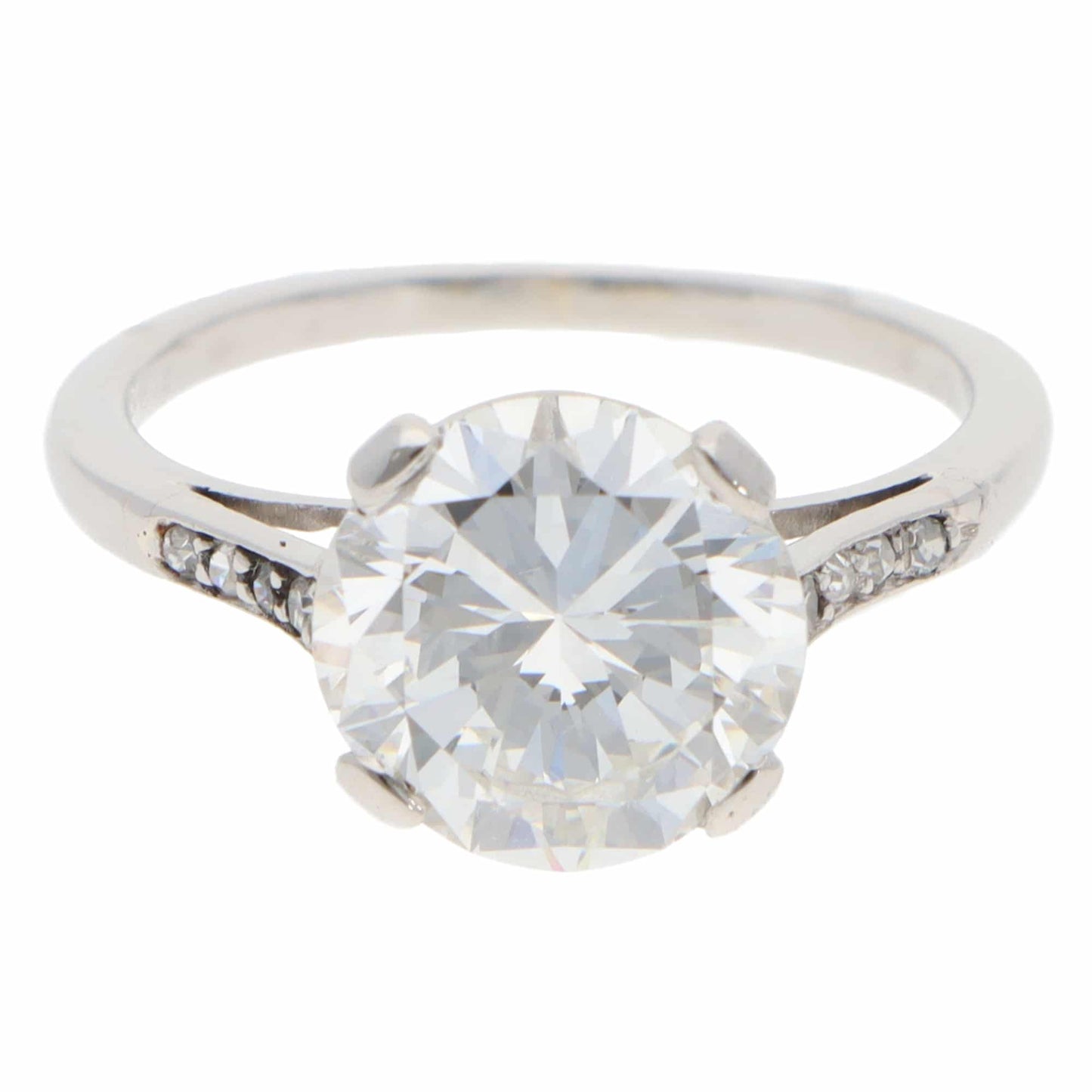 A large round brilliant cut diamond ring in platinum, on a white background