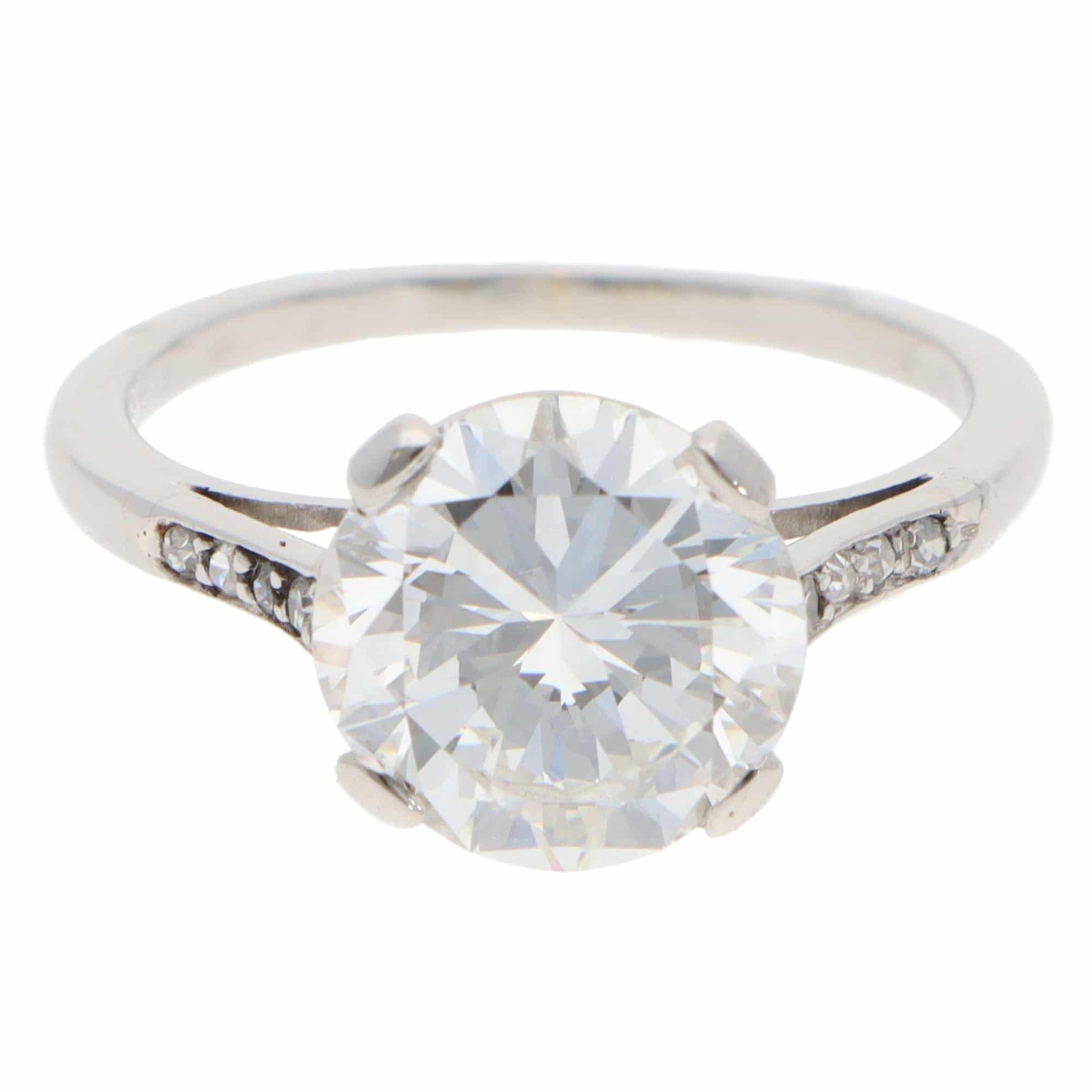A large round brilliant cut diamond ring in platinum, on a white background