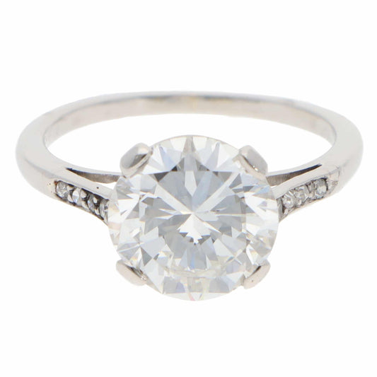 A large round brilliant cut diamond ring in platinum, on a white background