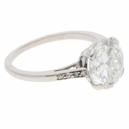 A large round brilliant cut diamond ring in platinum, on a white background