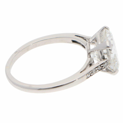 A large round brilliant cut diamond ring in platinum, on a white background