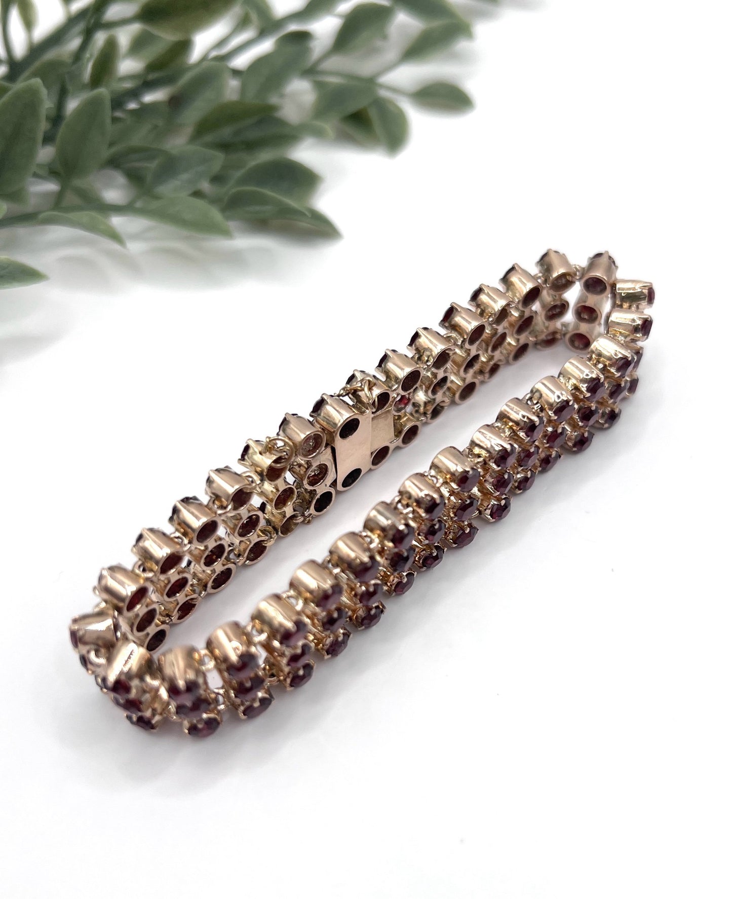 A triple row garnet bracelet in rose gold