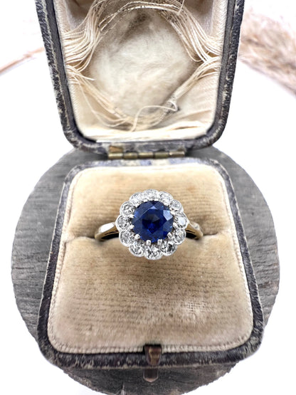 A sapphire and diamond flower cluster ring in yellow gold and platinum, in a ring box