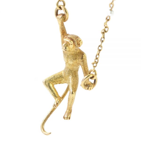 Art Deco 18ct Yellow Gold Monkey Brooch with Pearls; novelty "Monkey Around" brooch crafted from 18ct yellow gold with textured detailing and accented with two pearls. Made in France, Circa 1920