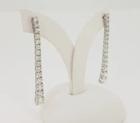 Diamond Set Long Drop Earrings, set with graduated diamonds, 2.40 carat total, claw set, in 18ct white gold. Post and butterfly fittings.