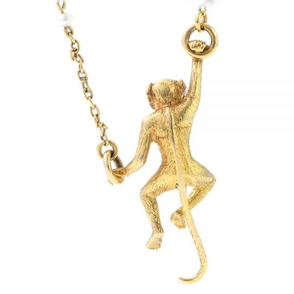 Art Deco 18ct Yellow Gold Monkey Brooch with Pearls; novelty "Monkey Around" brooch crafted from 18ct yellow gold with textured detailing and accented with two pearls. Made in France, Circa 1920