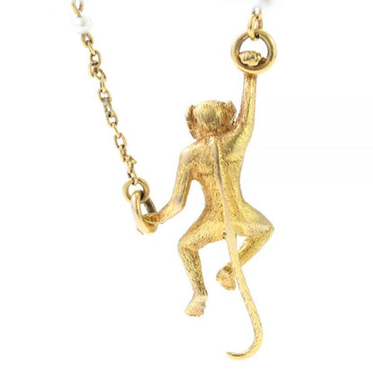 Art Deco 18ct Yellow Gold Monkey Brooch with Pearls; novelty "Monkey Around" brooch crafted from 18ct yellow gold with textured detailing and accented with two pearls. Made in France, Circa 1920