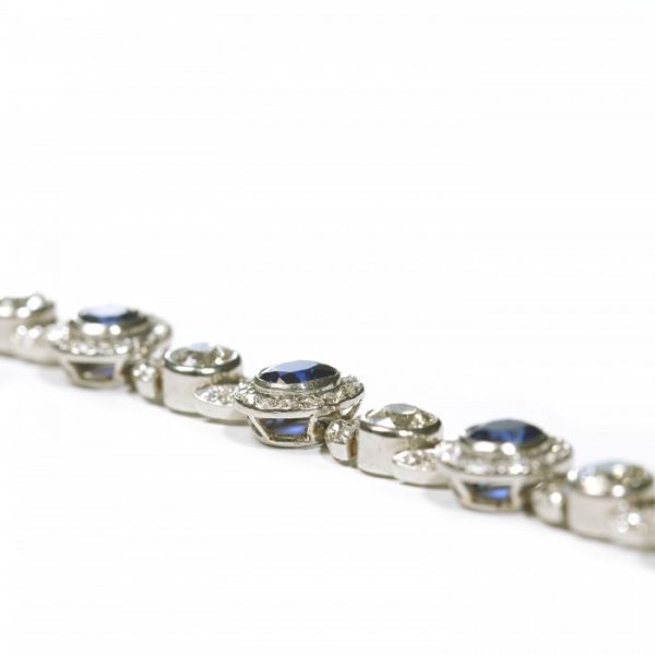 Belle Epoque Burmese Sapphire and Old Cut Diamond Bracelet in Platinum; comprised of round Burmese sapphire and diamond clusters, connected by diamond-set leaf motifs with a round old-cut diamond between each. Circa 1900. Sapphires 5.25 carats, Diamonds 9.50 carats